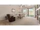 Spacious living room featuring a comfortable seating area and sliding glass door to the backyard at 14556 W Shaw Butte Dr, Surprise, AZ 85379