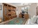 Bright office with a beautiful built-in bookcase, large wooden desk, and plantation shutters at 14556 W Shaw Butte Dr, Surprise, AZ 85379