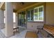 Covered patio with bench and view to the yard featuring privacy windows and relaxing atmosphere at 14556 W Shaw Butte Dr, Surprise, AZ 85379