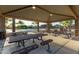 A covered picnic area features metal picnic tables and benches for outdoor dining at 14556 W Shaw Butte Dr, Surprise, AZ 85379