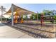 Community playground with swings, slides, and shaded seating for families at 14556 W Shaw Butte Dr, Surprise, AZ 85379