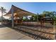 A colorful and well-equipped playground area with slides, swings, and shaded seating, designed for Gathering fun and recreation at 14556 W Shaw Butte Dr, Surprise, AZ 85379