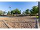 Recreational sand volleyball court surrounded by trees and walking paths in a community park at 14556 W Shaw Butte Dr, Surprise, AZ 85379