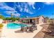 Beautiful backyard featuring a pool, outdoor seating, and lush landscaping under a sunny sky at 15212 N 53Rd St, Scottsdale, AZ 85254
