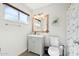 Neat bathroom with a gray vanity, framed mirror, and a shower with a marble-like curtain at 15212 N 53Rd St, Scottsdale, AZ 85254