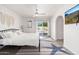 Bright main bedroom with a ceiling fan, and access to a private patio and pool at 15212 N 53Rd St, Scottsdale, AZ 85254