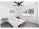 Well-lit bedroom featuring a white metal bed frame, neutral decor, and wood-look flooring at 15212 N 53Rd St, Scottsdale, AZ 85254