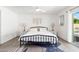 Bright main bedroom with a ceiling fan, stylish lamps, and a view of the outdoor pool area at 15212 N 53Rd St, Scottsdale, AZ 85254