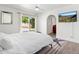 Bright main bedroom with a ceiling fan, and access to a private patio overlooking a pool at 15212 N 53Rd St, Scottsdale, AZ 85254