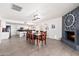 Spacious dining room with direct access to the kitchen and a cozy fireplace that adds warmth and character at 15212 N 53Rd St, Scottsdale, AZ 85254