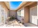 Inviting front porch with a seating area, decorative lantern, and shade, a relaxing welcome to your home at 15212 N 53Rd St, Scottsdale, AZ 85254