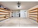 Spacious garage with ample storage shelves, neutral walls, and multiple access doors at 15212 N 53Rd St, Scottsdale, AZ 85254