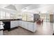 Open-concept kitchen features counter seating flowing into the dining area and outdoor pool access at 15212 N 53Rd St, Scottsdale, AZ 85254