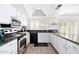 Modern kitchen offering stainless steel appliances, bright white cabinets, stone countertops and breakfast bar at 15212 N 53Rd St, Scottsdale, AZ 85254