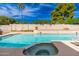 Serene pool with a built-in spa, set against a backdrop of lush greenery and clear skies at 15212 N 53Rd St, Scottsdale, AZ 85254