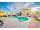Backyard view of a refreshing pool with an adjacent patio and lush landscaping at 17225 N 51St Dr, Glendale, AZ 85308