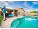Backyard view of an inground swimming pool and large patio with shade cover at 17225 N 51St Dr, Glendale, AZ 85308