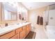Large bathroom featuring double sinks, granite counters, and a separate shower and bathtub at 17225 N 51St Dr, Glendale, AZ 85308