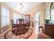 Formal dining room with a round table, hardwood floors, and shutters on the windows at 17225 N 51St Dr, Glendale, AZ 85308