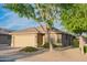 Charming single-story home with a well-manicured front yard, desert landscaping, and a neutral color palette at 17225 N 51St Dr, Glendale, AZ 85308
