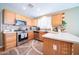 Well-equipped kitchen with stainless steel appliances, hardwood floors, and tile backsplash at 17225 N 51St Dr, Glendale, AZ 85308