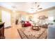 Bright, open living room with hardwood floors, a ceiling fan, and comfortable furniture at 17225 N 51St Dr, Glendale, AZ 85308