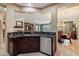 Open-concept kitchen with stainless steel appliances, custom cabinetry, and a view of living and dining areas at 1788 W Dion Dr, Anthem, AZ 85086