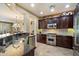 A chef's kitchen with stainless steel appliances and dark wood cabinets offers a luxurious cooking experience at 1788 W Dion Dr, Anthem, AZ 85086