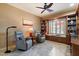 Office with two upholstered chairs, window shutters, and built-in bookshelves at 1788 W Dion Dr, Anthem, AZ 85086