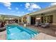 Backyard pool featuring a waterfall and an outdoor dining area at 1788 W Dion Dr, Anthem, AZ 85086