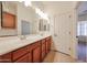 Well-lit bathroom features double sink vanity with wooden cabinets at 17947 W Jojoba Rd, Goodyear, AZ 85338