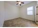 Bedroom featuring tile floors, window, and ceiling fan at 17947 W Jojoba Rd, Goodyear, AZ 85338
