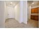 Open entryway with neutral tile flooring, recessed lighting, leading to the laundry room and front door at 17947 W Jojoba Rd, Goodyear, AZ 85338