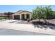 Charming single-story home featuring a well-maintained front yard, desert landscaping, and a cozy front porch at 17947 W Jojoba Rd, Goodyear, AZ 85338