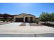 Well-manicured single-story home with desert landscaping, neutral color palette, and attached two-car garage at 17947 W Jojoba Rd, Goodyear, AZ 85338