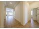 Spacious hallway with tile flooring, neutral paint, and a view into the living spaces at 17947 W Jojoba Rd, Goodyear, AZ 85338