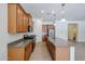 Open kitchen boasts stainless steel appliances, large island, and granite countertops at 17947 W Jojoba Rd, Goodyear, AZ 85338