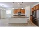 Modern kitchen features granite countertops, stainless steel appliances, and an island at 17947 W Jojoba Rd, Goodyear, AZ 85338