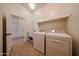 Functional laundry room includes washer, dryer, and sink at 17947 W Jojoba Rd, Goodyear, AZ 85338