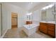 Bright main bathroom featuring dual vanities, a soaking tub, and a separate shower enclosure at 17947 W Jojoba Rd, Goodyear, AZ 85338