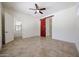 Spacious main bedroom featuring neutral walls, tile flooring, and modern barn door to bathroom at 17947 W Jojoba Rd, Goodyear, AZ 85338