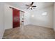 Large main bedroom featuring a barn door, tiled floor and natural light at 17947 W Jojoba Rd, Goodyear, AZ 85338
