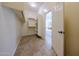 Walk-in closet featuring custom shelves, lots of light, and open doorway to bathroom at 17947 W Jojoba Rd, Goodyear, AZ 85338