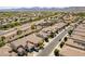Wide aerial view of a neighborhood with tree-lined streets, mature landscaping, and well-maintained homes at 18003 W Carmen Dr, Surprise, AZ 85388