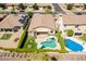 Aerial view of a home with a backyard featuring a pool, covered patio, manicured lawn, and privacy hedges at 18003 W Carmen Dr, Surprise, AZ 85388