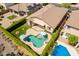 Aerial view of a house featuring an inground pool, covered patio, firepit, and privacy landscaping at 18003 W Carmen Dr, Surprise, AZ 85388