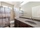 Bathroom with vanity, shower, and decorative shower curtain at 18003 W Carmen Dr, Surprise, AZ 85388