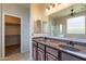 Bathroom featuring double sinks, granite countertops, and a separate shower at 18003 W Carmen Dr, Surprise, AZ 85388