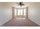 Bright bedroom with large windows and neutral carpet, ready for personalization at 18003 W Carmen Dr, Surprise, AZ 85388