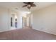 Well-lit bedroom featuring access to the walk-in closet and ensuite with carpeted floors at 18003 W Carmen Dr, Surprise, AZ 85388
